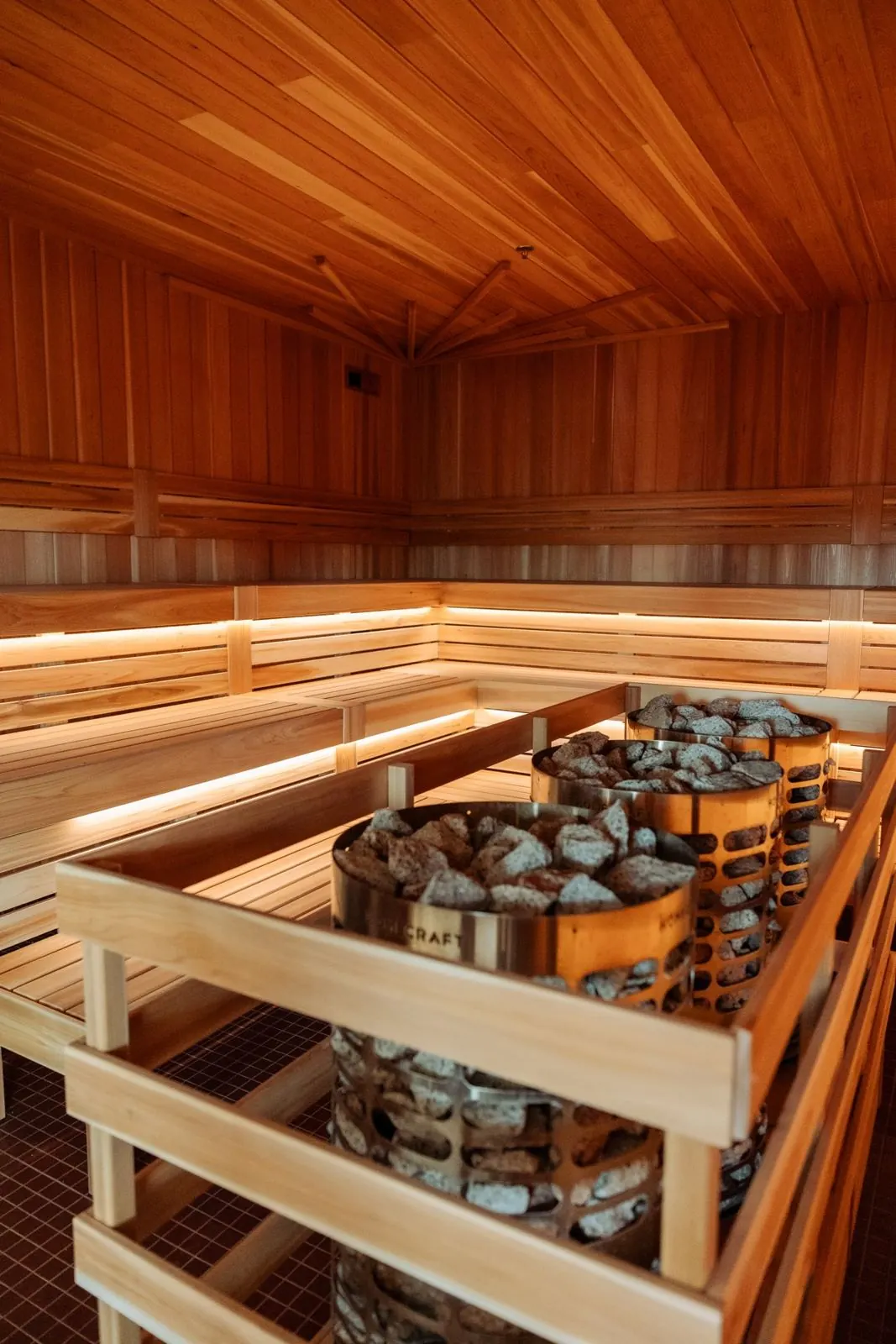 Tiered cedar benches inside the sauna at The Good Spot