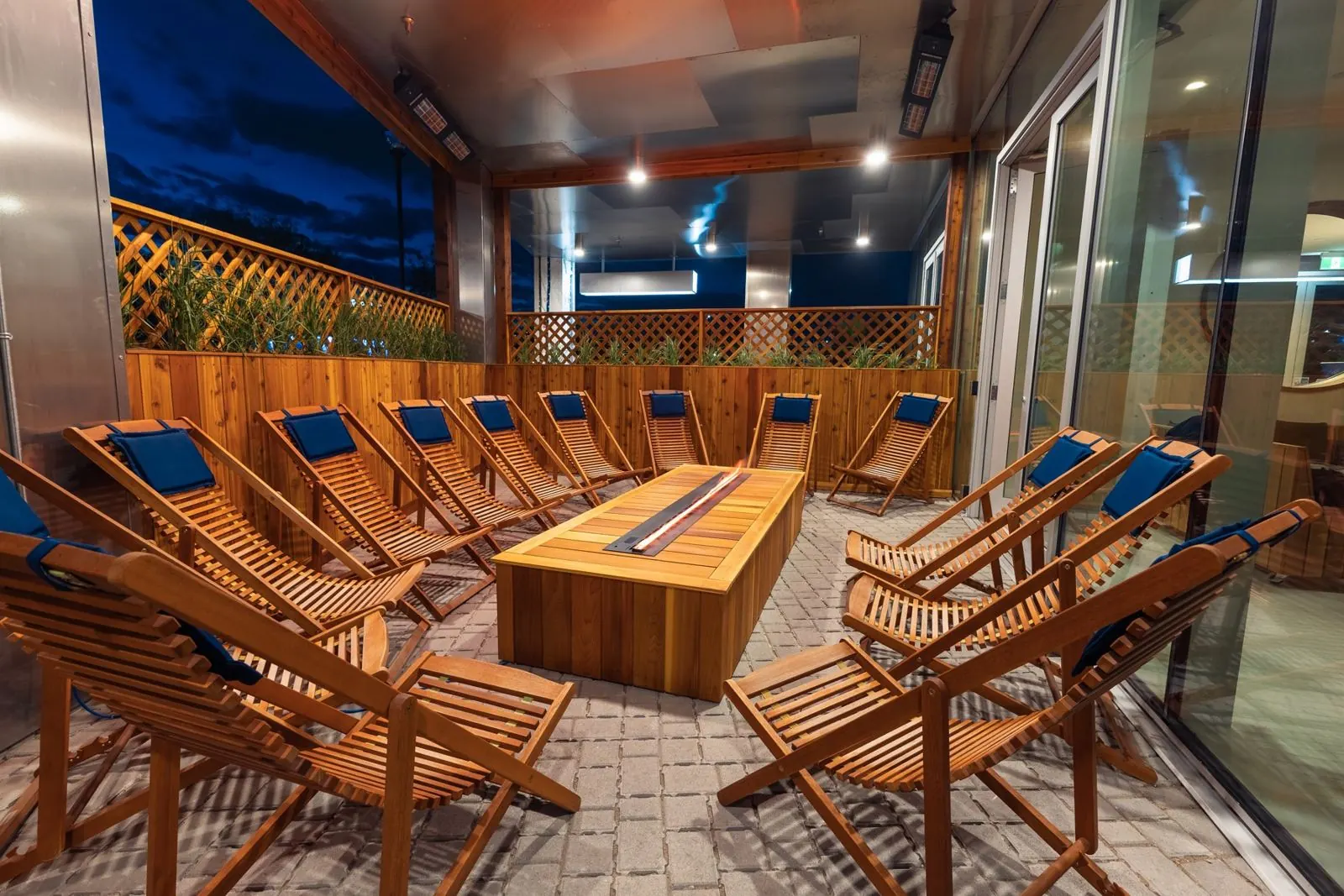 Covered patio with lounge chairs around a fire table